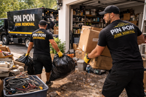 Pin Pon Junk Removal crew hauling boxes and bags from a cluttered garage during a garage cleanout in Ontario, CA