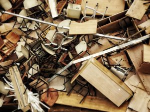 Pile of discarded wooden furniture and chairs awaiting junk removal in Eastvale CA