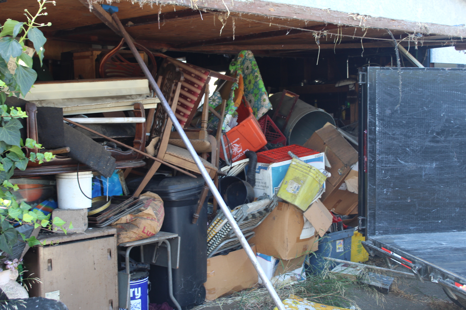 Truck hauling away bulky household items including furniture from a suburban Inland Empire home — mattress disposal service in San Bernardino CA